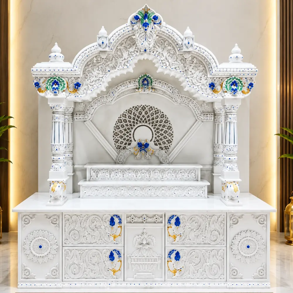 Carved marble pillars and arched niche of a home mandir