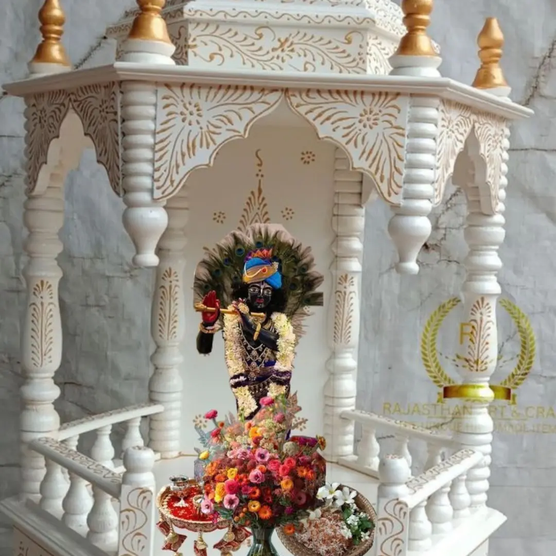 Large white temple with several carved domes