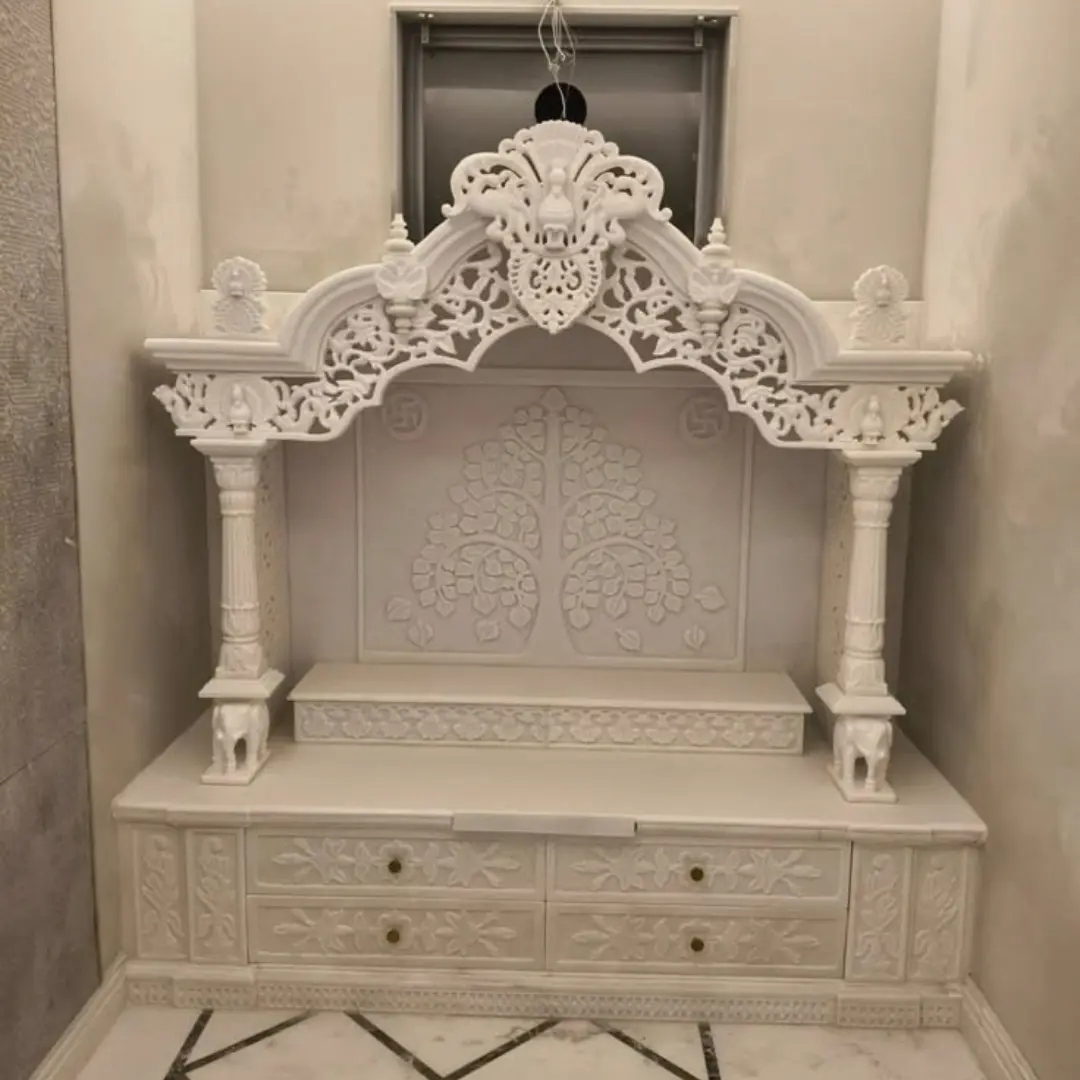 Large white temple with several carved domes
